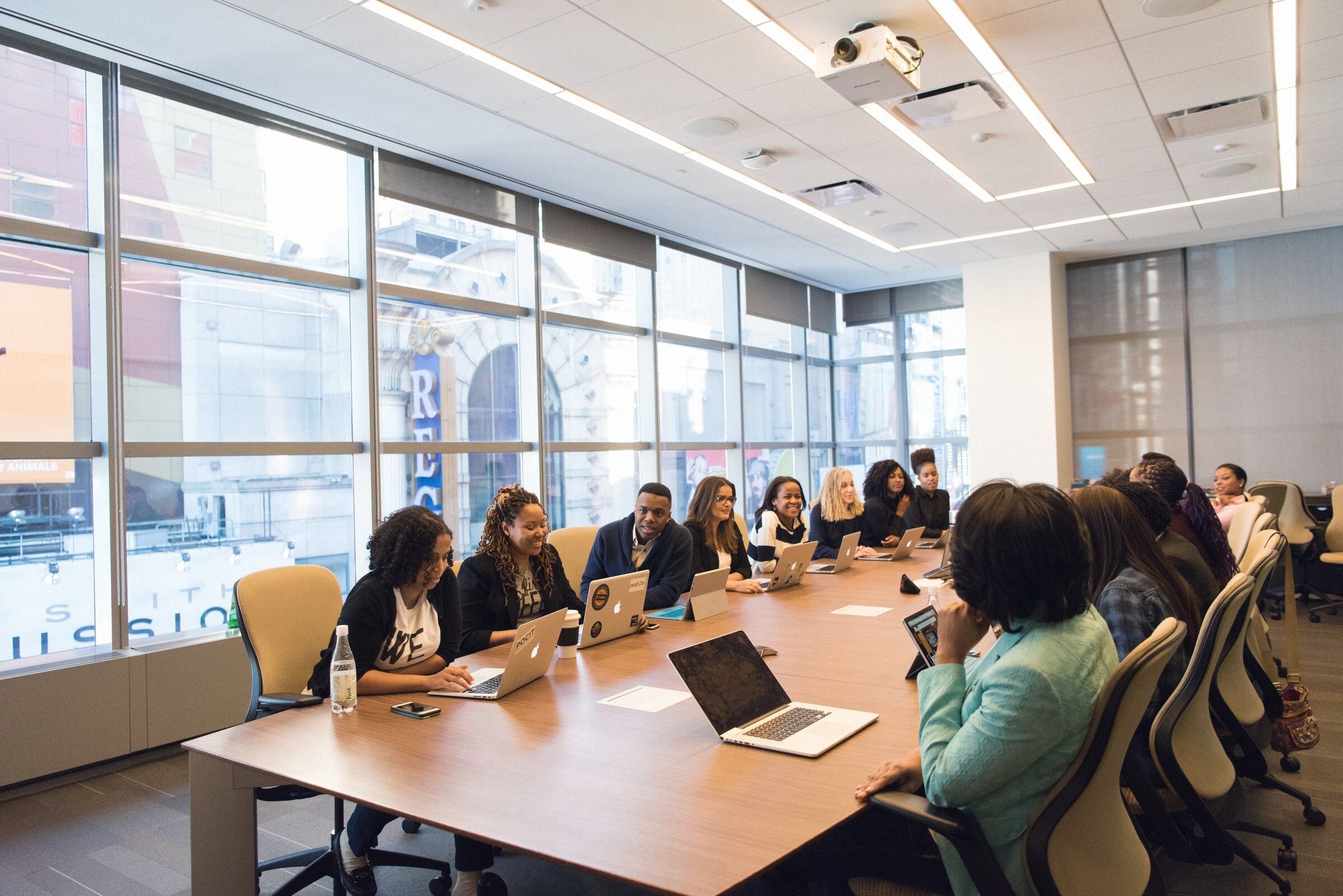 A facilitated Armourware session: a team around a boardroom table, laptops open, working through a scenario.